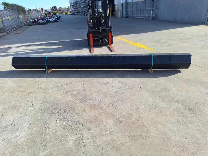 Long metal beam near forklift outdoors