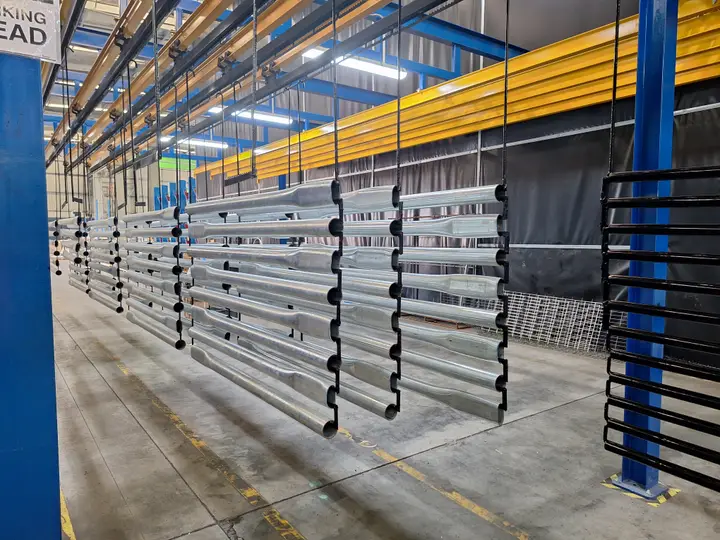 Metal parts on hanging conveyor system